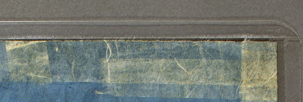 Image of adhesive from a double-sided tape encapsulation creeping out and adhering to the encapsulated object.