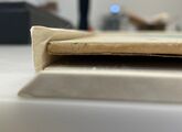 Side view of a flexible support holding an artwork.