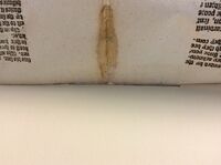 The pull-through hinge/slit can barely be seen when the object is lifted from the backmat.
