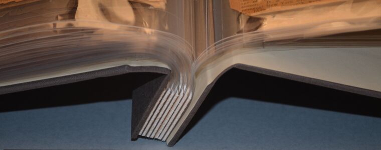 Detail of scrapbook rebound into polyester encapsulated post binding. The stubs compensate for the thickness of the pages. Emory University.