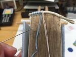 Sewing a secondary front bead endband in two colors of silk thread over a primary endband of linen thread.