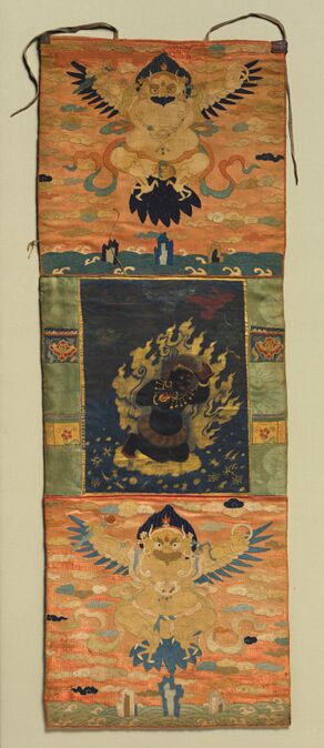 Vajrapani and Garuda, painting c. 1650; top and bottom borders c. 1350. Attributed to Choying Dorje, the Tenth Black Hat Karmapa (Tibetan, 1604–1674). Painting: gum tempera, gold, and silver on silk; lateral borders: silk damask with needleloop embroidery; top and bottom panels: embroidered silk, lead, and silver paper; curtain: silk tabby; dowels: wood, rawhide, and leather; overall: 114.6 x 44.5 cm (45 1/8 x 17 1/2 in.). The Cleveland Museum of Art, Purchase from the J. H. Wade Fund, 1989.11