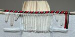 Finished Armenian-style endband, view from spine, with thick cord and linen thread primary (tiedowns through the boards) and red, black, and white silk secondary (with two additional cores).