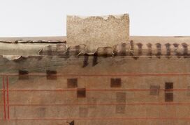 Sections of a polyester and paper laminate inserted under vellum for spine repair